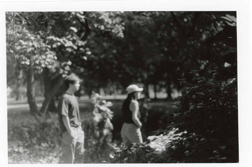 a picture of 2 people walking by in Carle Park.